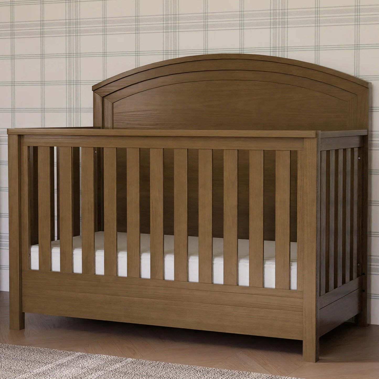 Farmhouse Heritage 4-in-1 convertible crib with curved headboard and textured wood finish