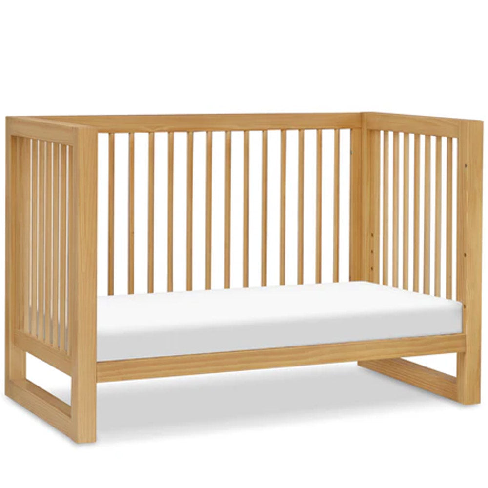 Nantucket 3-in-1 convertible crib in honey finish placed in a cozy nursery, ideal for Los Angeles parents seeking versatile baby furniture
