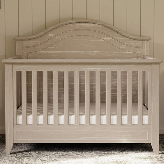 Barrow Rustic 4-in-1 Convertible Curve Top Crib in a modern nursery at Kids Furniture Superstore in Los Angeles.