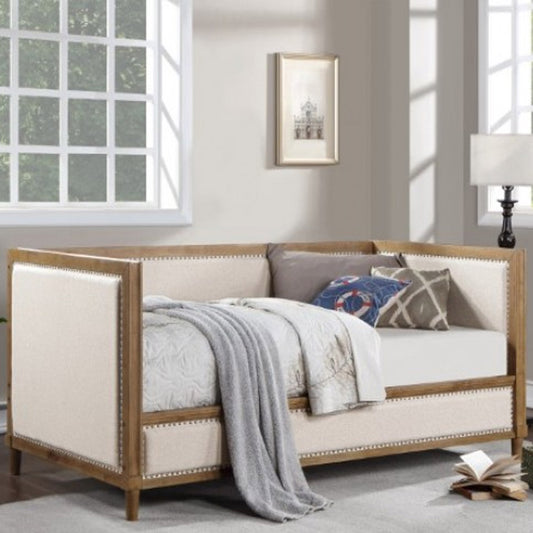 Beige daybed with light oak frame and nailhead trim in Los Angeles