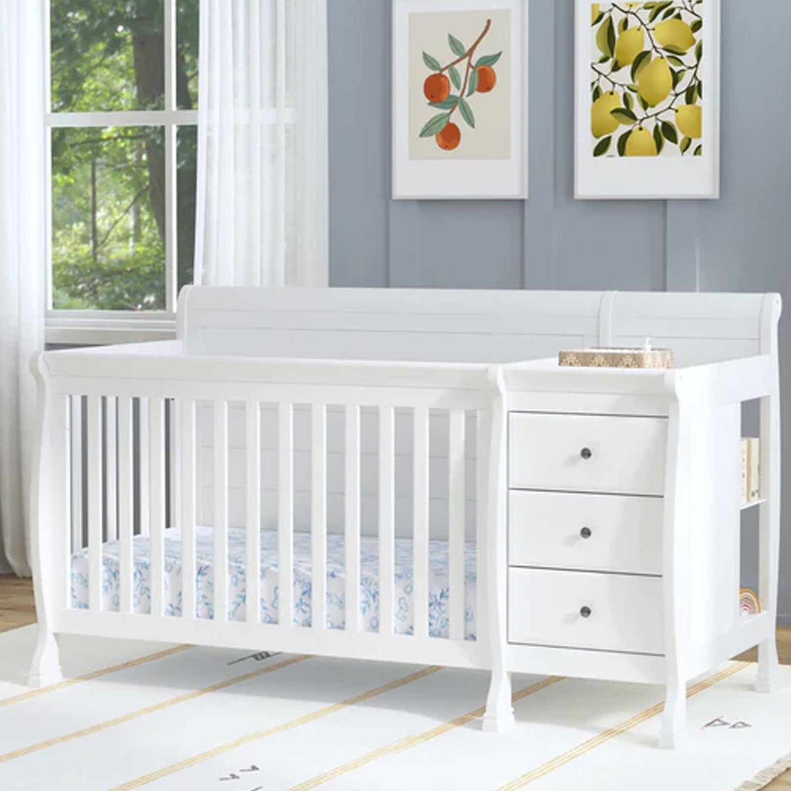 White convertible baby crib with built-in changing station demonstrating four growing stages from nursery to full-size bed.