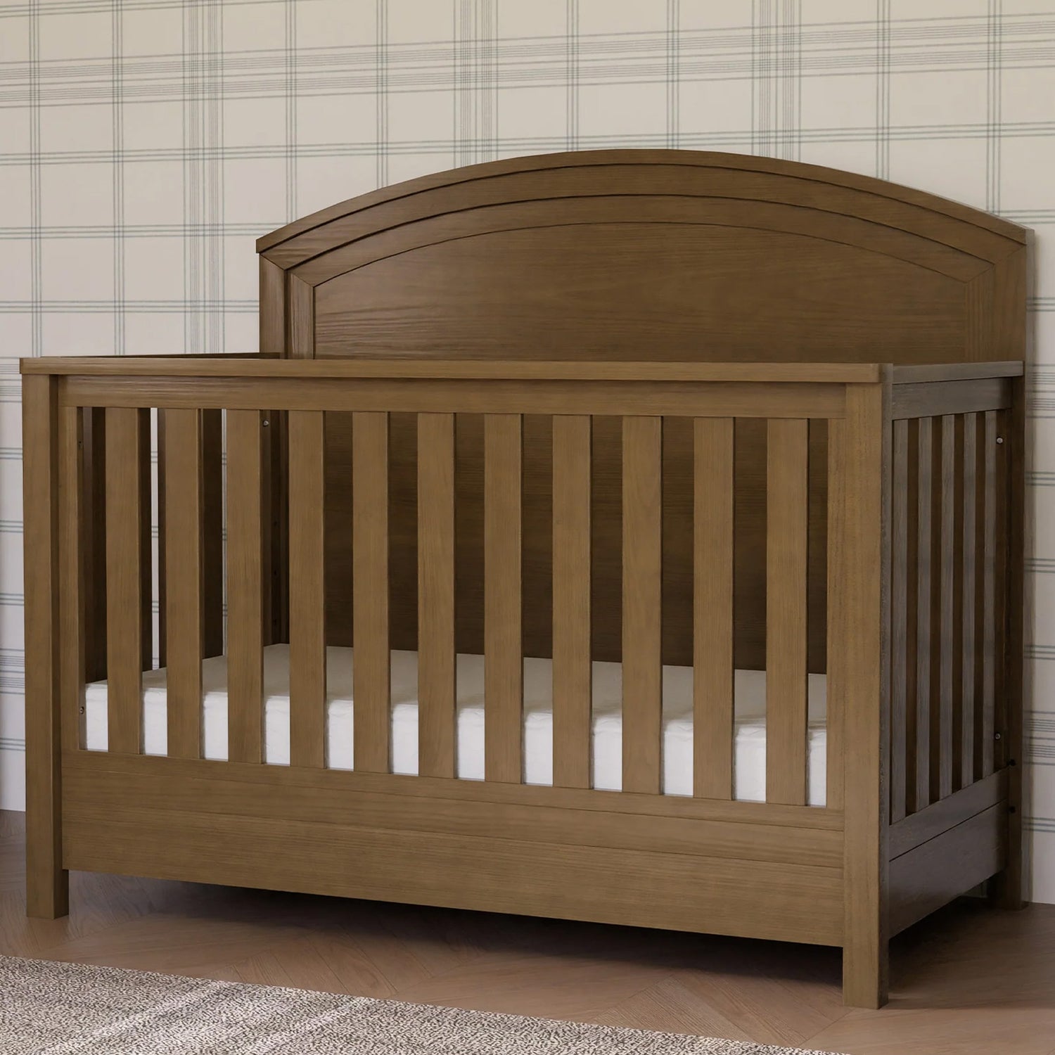 Farmhouse Heritage 4-in-1 convertible crib with curved headboard and textured wood finish