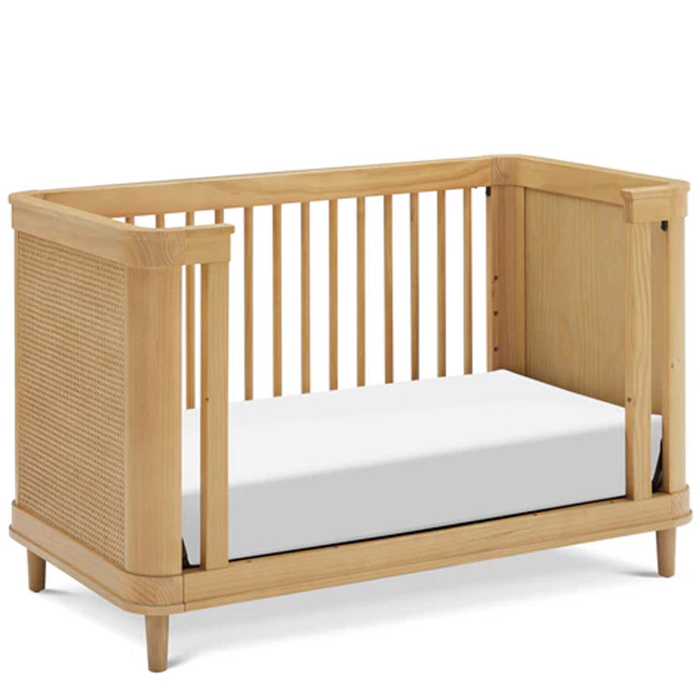 Marin 3-in-1 convertible crib in honey cane design placed in a cozy nursery, ideal for Pasadena, Glendale, and Eagle Rock parents