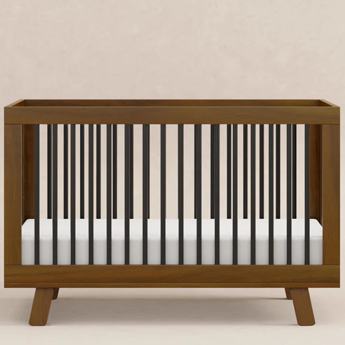 Mid-century modern Hudson baby crib with rounded spindle design that converts from a crib to a toddler bed and daybed