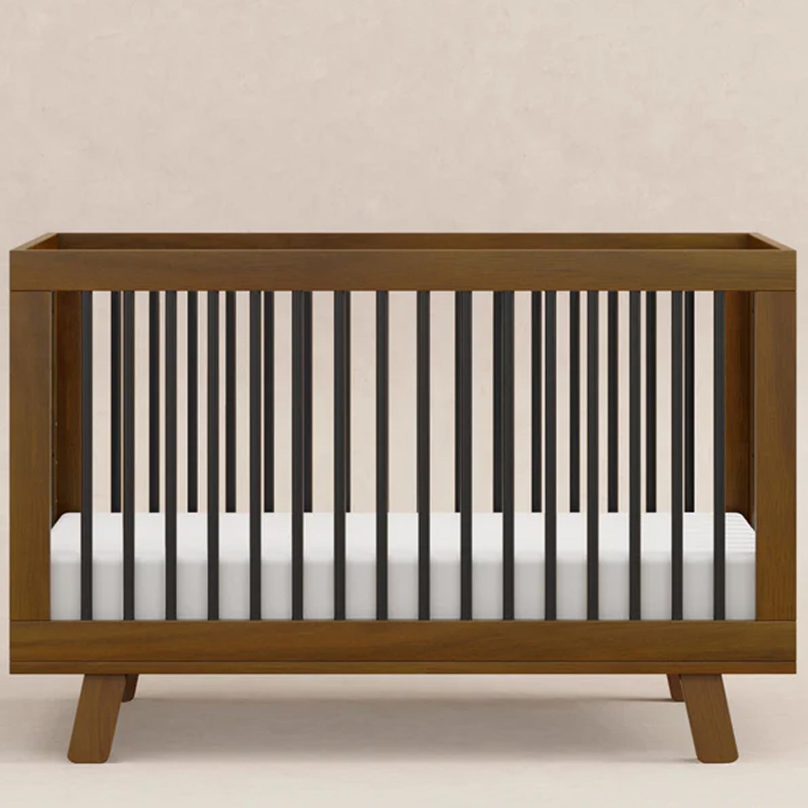 Mid-century modern Hudson baby crib with rounded spindle design that converts from a crib to a toddler bed and daybed