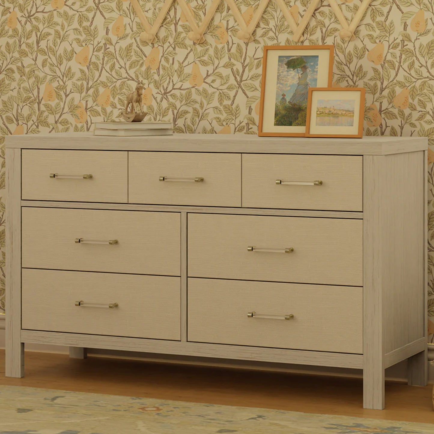 Elegant nursery dresser with fabric detailing and gold hardware