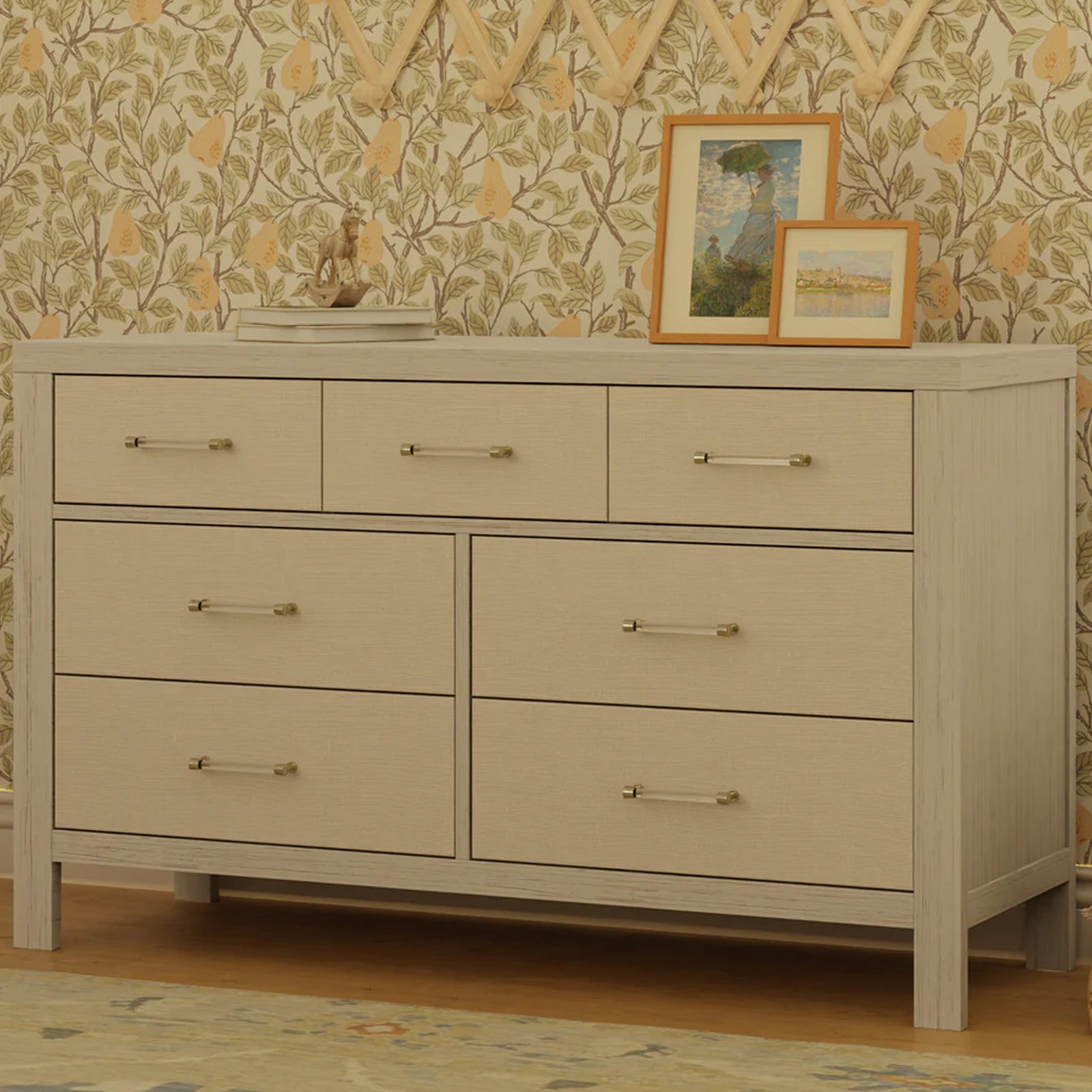 Elegant nursery dresser with fabric detailing and gold hardware